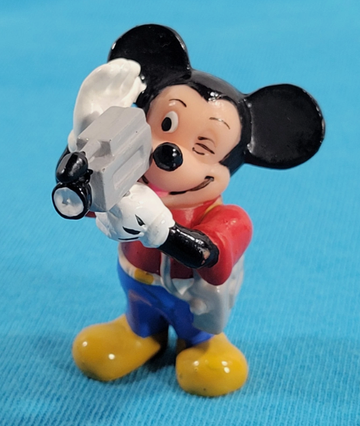 Vintage Mickey Mouse figurine holding a video camera